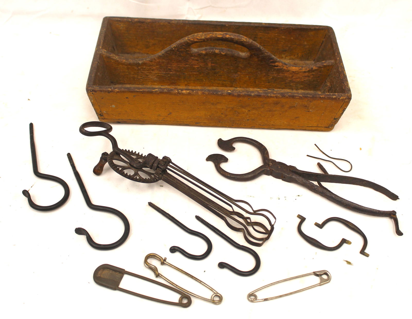 Antique utility tote in mustard with egg beater, sugar nips, hooks, etc - tote measures 4" tall x 13 (1 of 7)