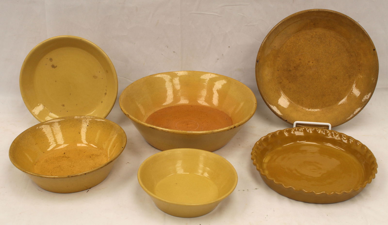Lot of 6 antique yellowware items incl 3 milk pans & 3 pie plates - milk pans are 7 1/2", 9 1/2" & (1 of 7)