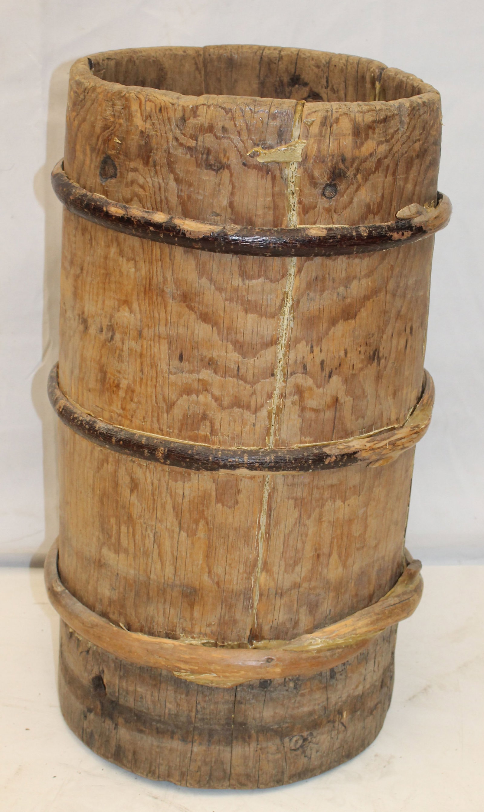 Antique banded hollowed out log barrel - 12" diam (out of round x 23" tall: Antique banded hollowed out log barrel - 12" diam (out of round x 23" tall