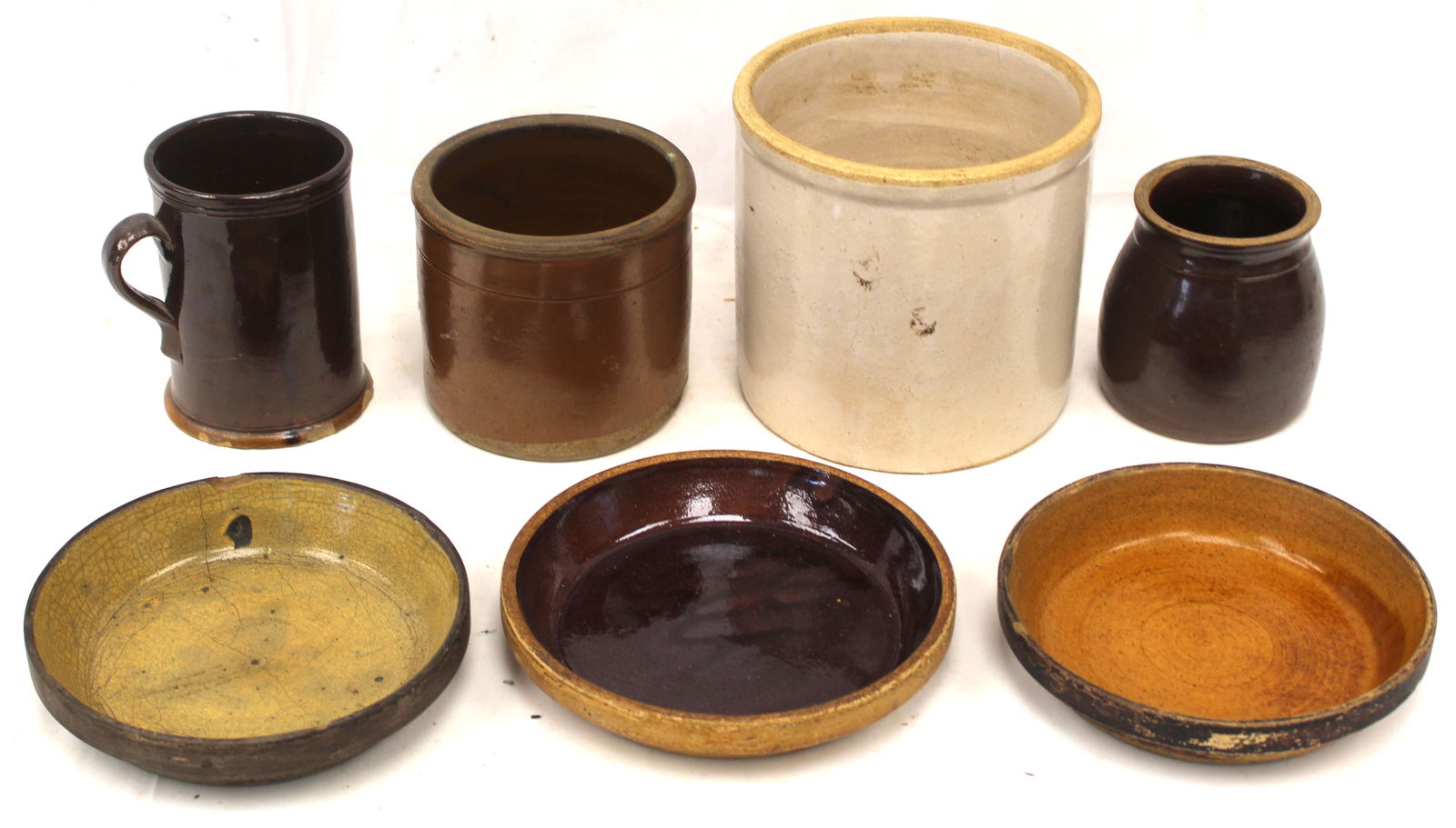 Lot of 7 stoneware items incl 2 crocks, large mug, jars & 3 plates - crocks 5 1/2" & 7" tall, mug (1 of 8)