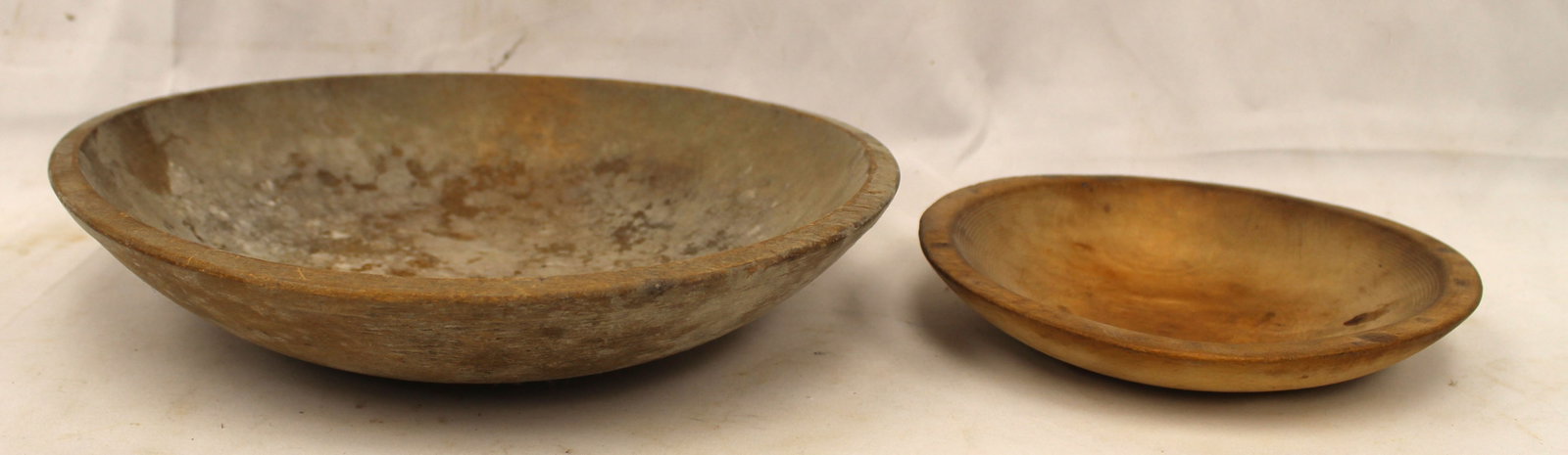 Lot of 2 antique wooden bowls in unpainted surfaces - 7" & 10" diam (out of round): Lot of 2 antique wooden bowls in unpainted surfaces - 7" & 10" diam (out of round)
