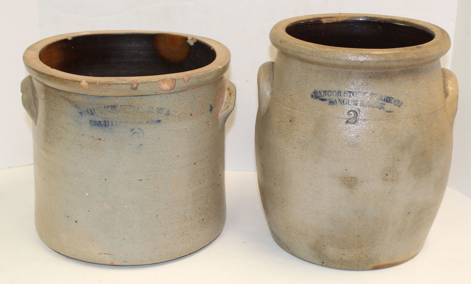 Lot of 2 stoneware 2 gal crocks incl 10" x 8" diam Bangor Stoneware Co ovoid & 9" x 10" diam: Lot of 2 stoneware 2 gal crocks incl 10" x 8" diam Bangor Stoneware Co ovoid & 9" x 10" diam Gardiner Stoneware Co