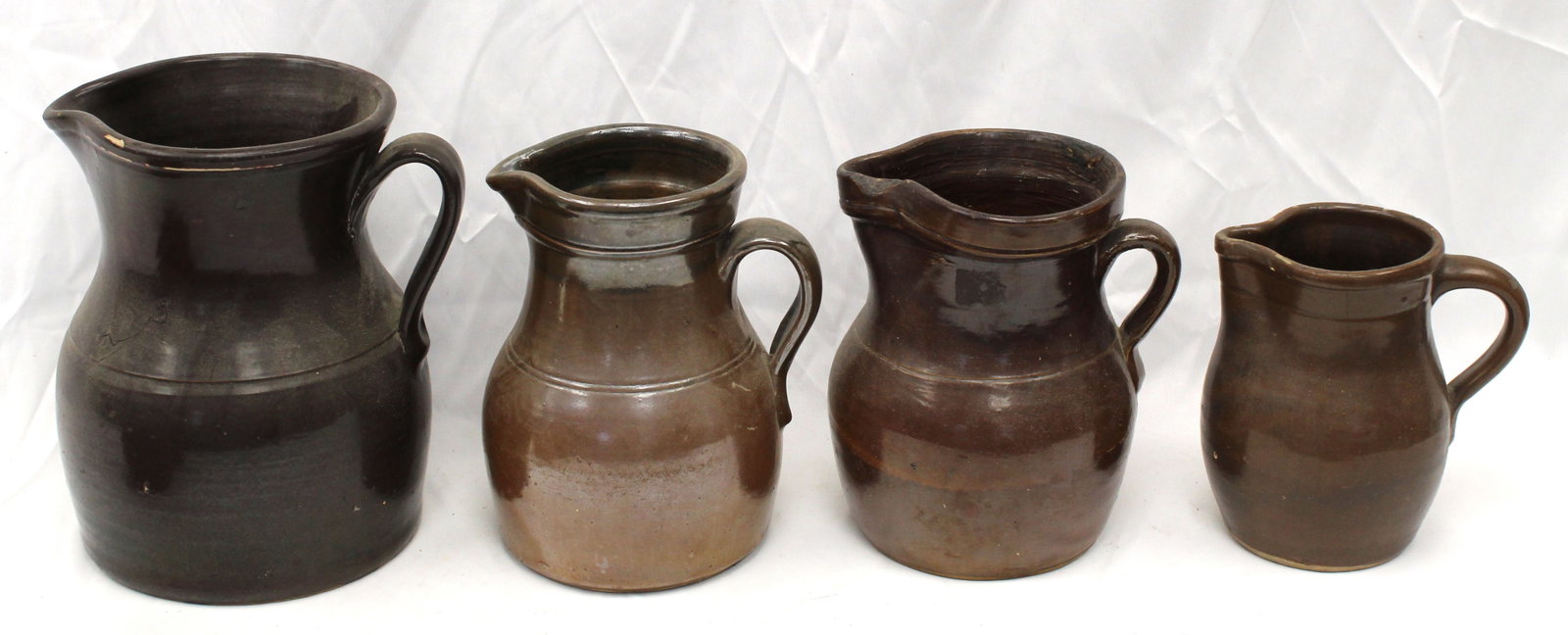 Lot of 4 stoneware pitchers - 6 1/4", 8", 8 1/4" & 9" tall: Lot of 4 stoneware pitchers - 6 1/4", 8", 8 1/4" & 9" tall