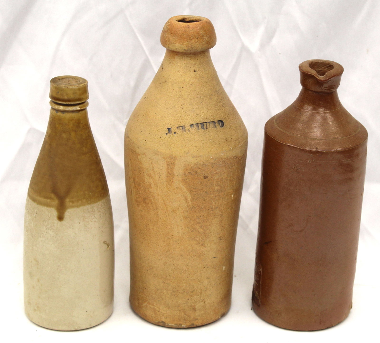 Lot of 3 stoneware bottles incl 1 by J.H. Hurd & 1 by J. Bourne & Son - 9 1/2", 10 1/2" & 11" tall: Lot of 3 stoneware bottles incl 1 by J.H. Hurd & 1 by J. Bourne & Son - 9 1/2", 10 1/2" & 11" tall