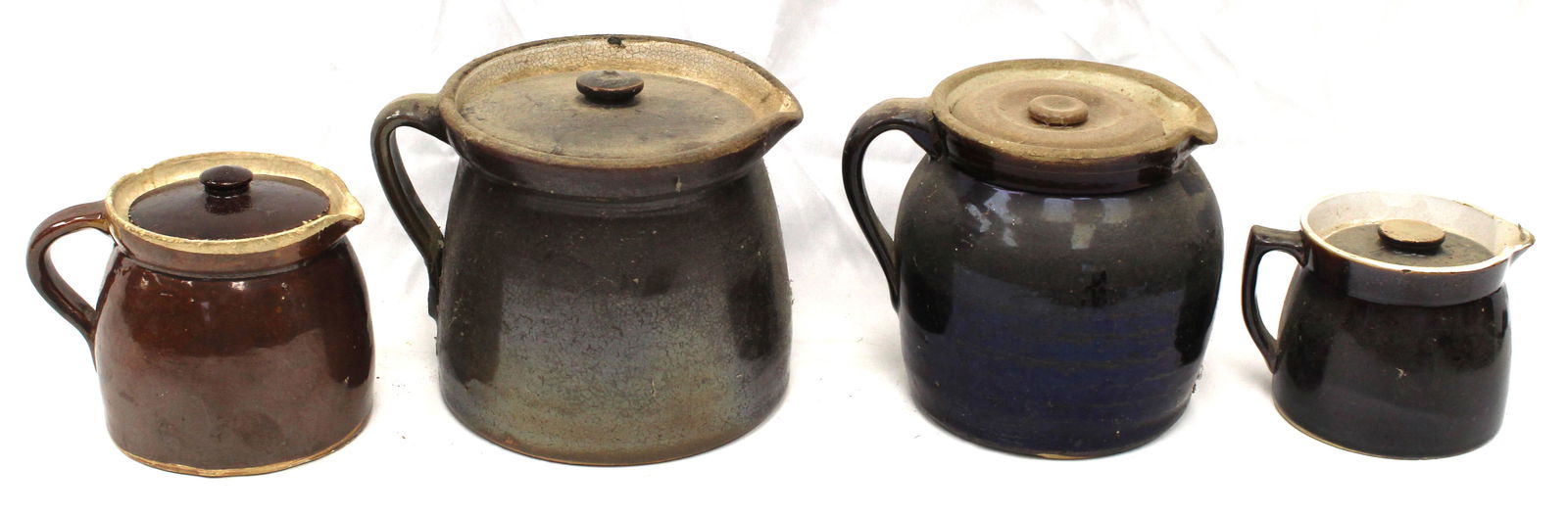 Lot of 4 stoneware syrup jugs w lids - 4", 4 1/2", 6" & 6 1/2" tall: Lot of 4 stoneware syrup jugs w lids - 4", 4 1/2", 6" & 6 1/2" tall