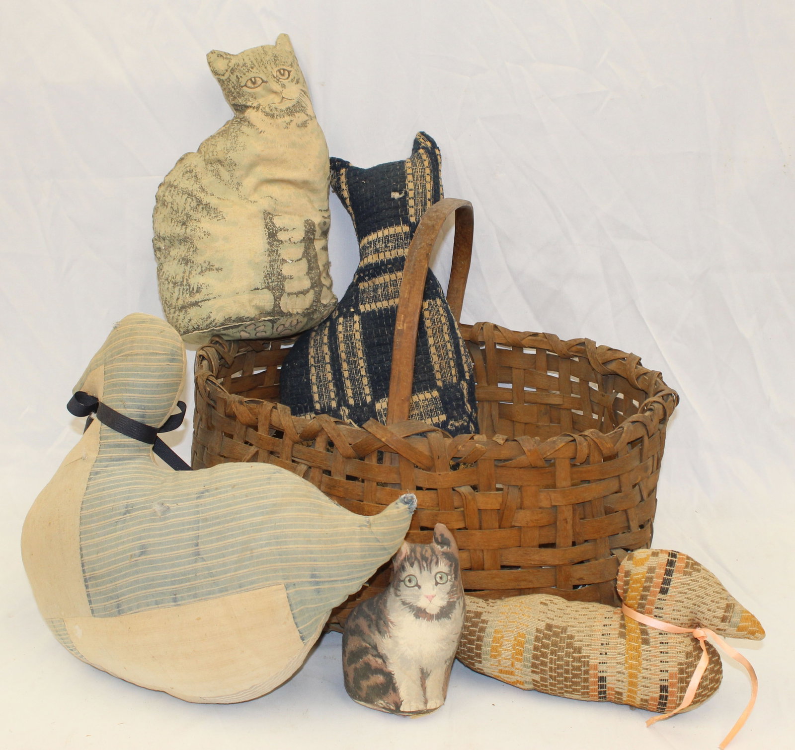 Antique basket filled with early stuffed rag animals - cats & bunnies: Antique basket filled with early stuffed rag animals - cats & bunnies