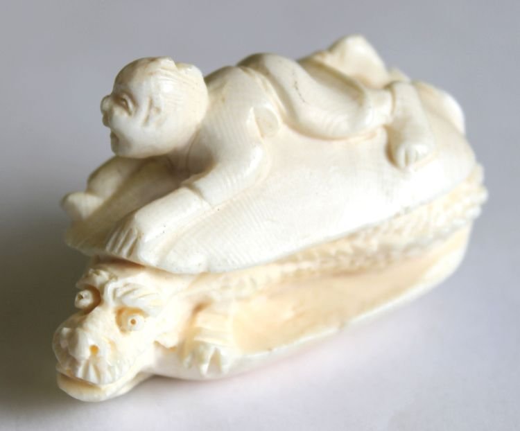 Japanese carved ivory netsuke of boy riding clamsh: Japanese carved ivory netsuke of boy riding clamshell w dragon inside - 2 1/4" wide
