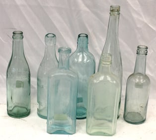 Lot of 7 aqua glass bottles in various shapes - 9" - 12" tall