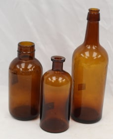 Lot of 3 brown glass bottles in various shapes - 7"-12" tall