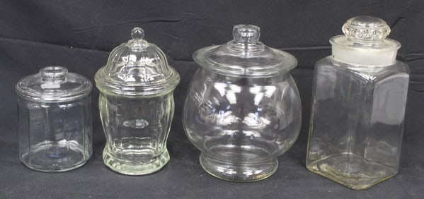 Lot of 4 covered clear glass candy/apothecary jars