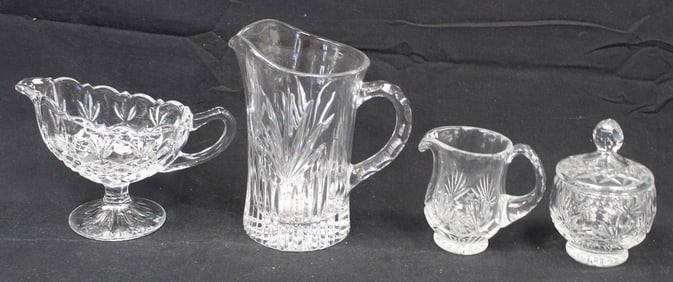 Lot of 4 cut glass items incl gravy, covered candy bowl & 2 pitchers