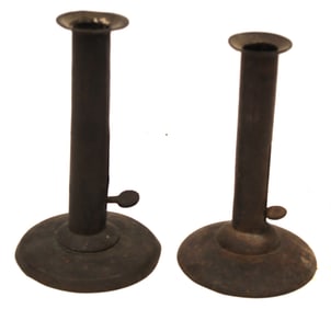 Near pair of tin hogscraper push up candlesticks