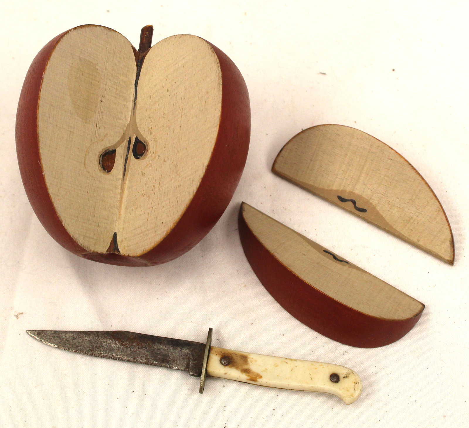 Carved wooden painted apple w 2 slices plus a small bone handled knife - approx 3": Carved wooden painted apple w 2 slices plus a small bone handled knife - approx 3"