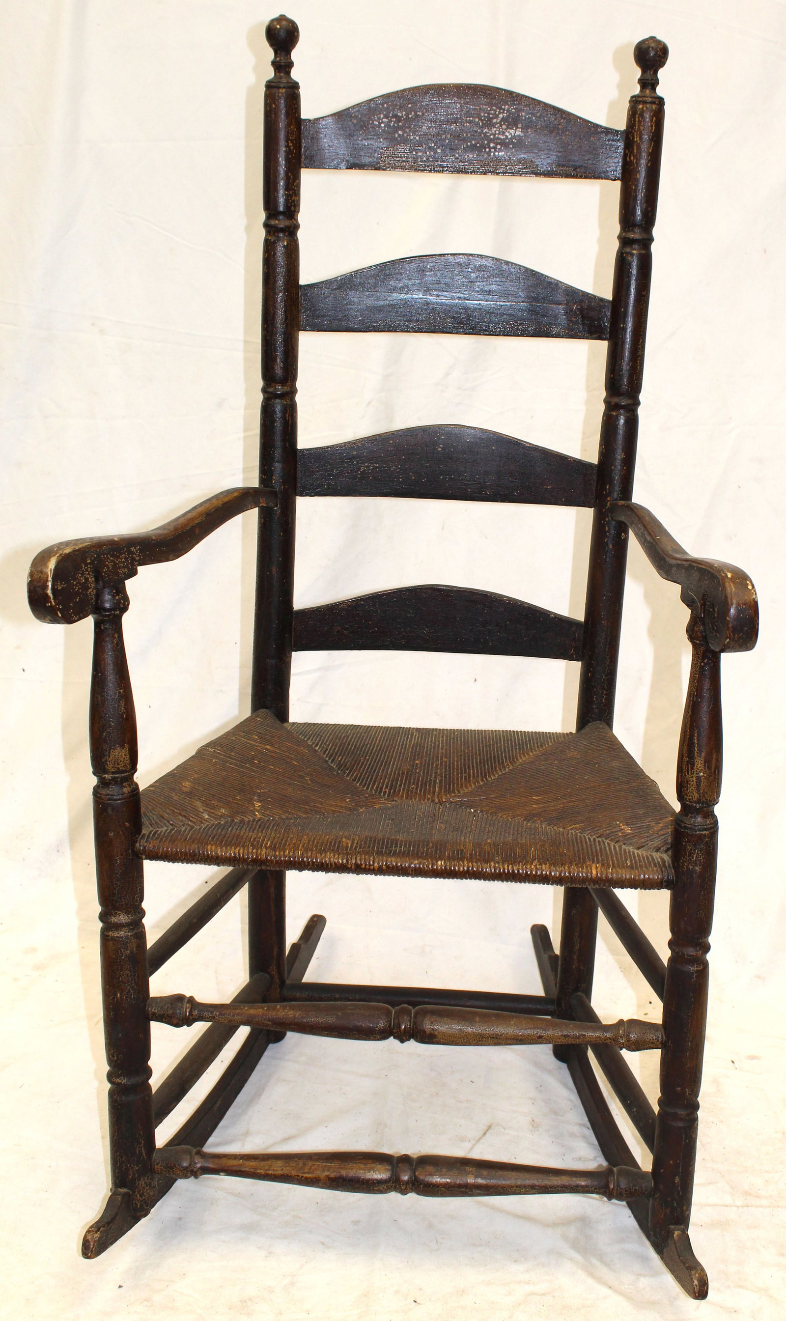 Antique ladderback rocking armchair in black w rush seat: Antique ladderback rocking armchair in black w rush seat