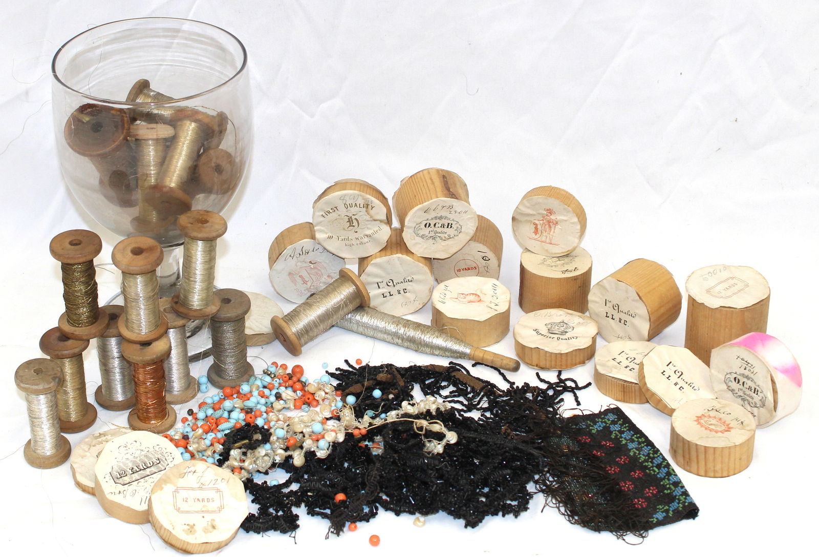 Large blown glass compote w metallic thread spools, empty ribbon spools & a beaded piece (1 of 5)