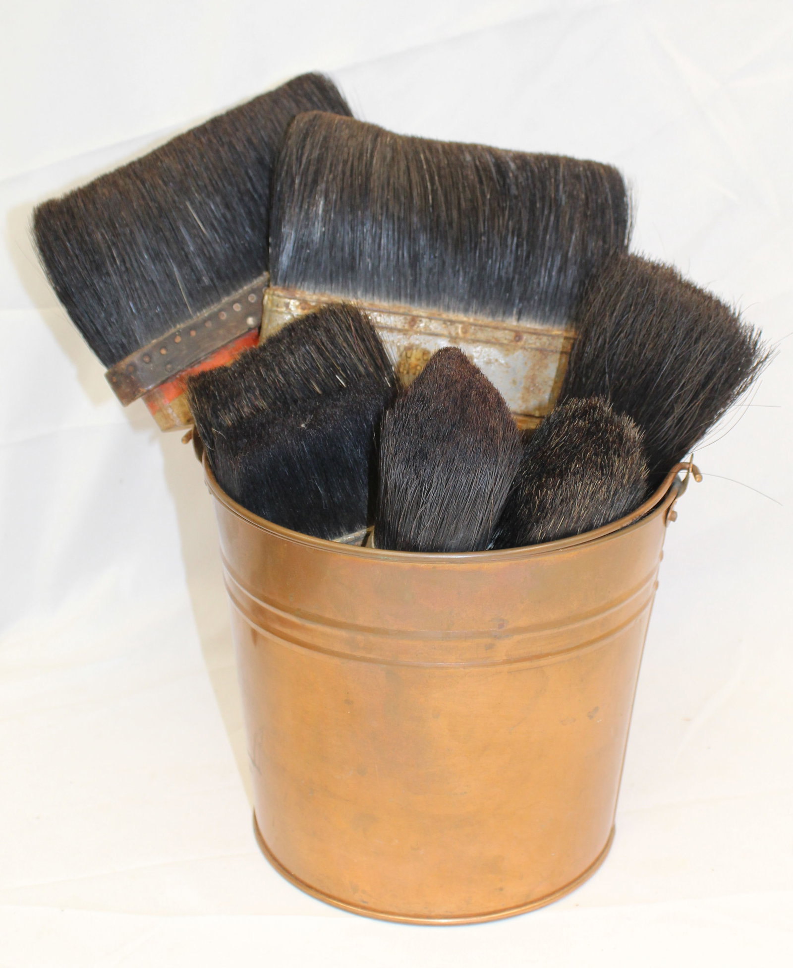 Brass bucket filled w vintage paint brushes: Brass bucket filled w vintage paint brushes