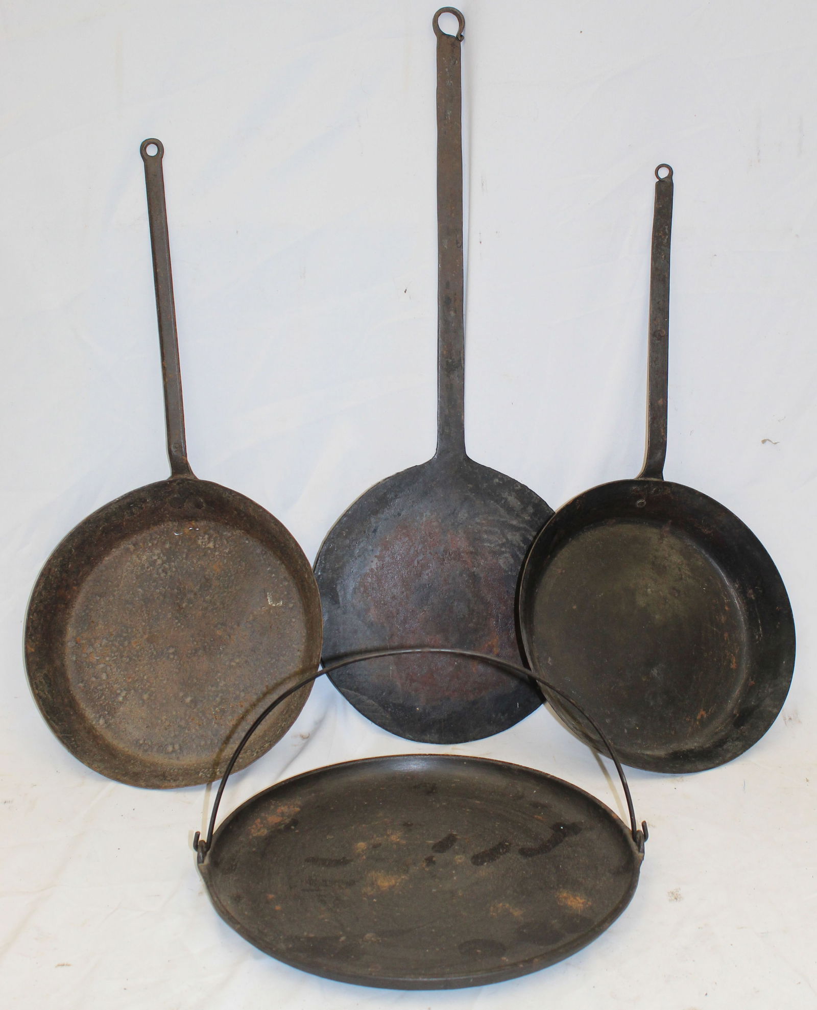 Lot of 4 cast iron skillets - 3 w long handles & 1 w bail handle - 11"x23", 10"x27", 11"x21" & 13" (1 of 4)