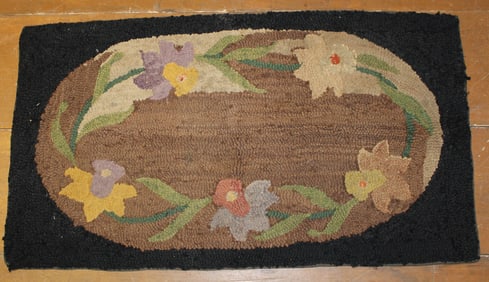 Hooked rug w oval center & floral motif