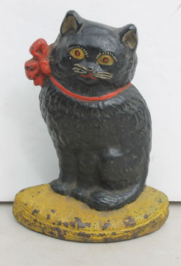 Hubley ca 1930's cast iron cat sitting on a pillow door: Hubley ca 1930's cast iron cat sitting on a pillow doorstop in orig paint - 8" tall