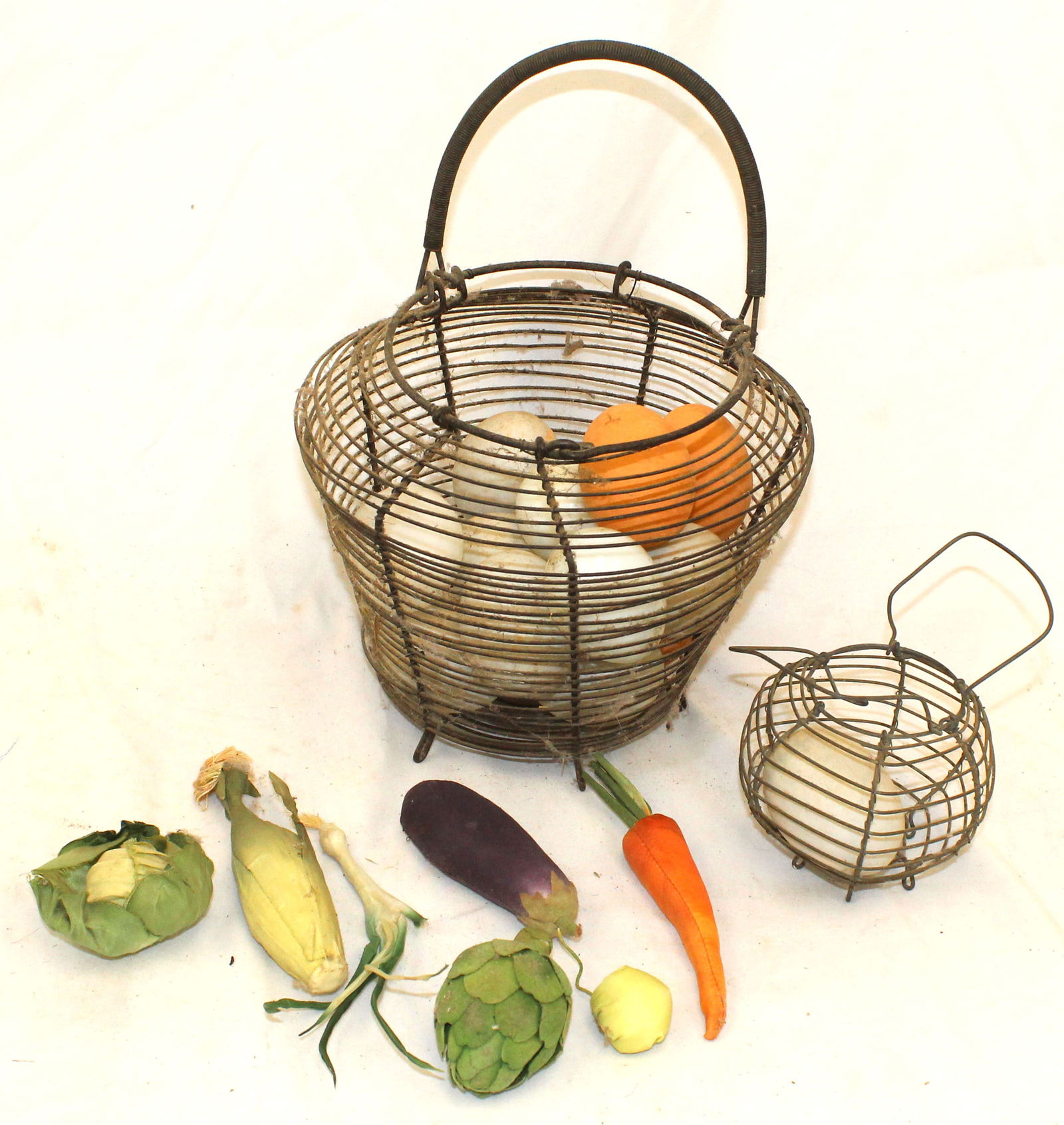 Lot of 2 wire egg baskets w glass & porcelain eggs & silk fruit - 8" diam x 10" & 4" diam x 3" (1 of 4)