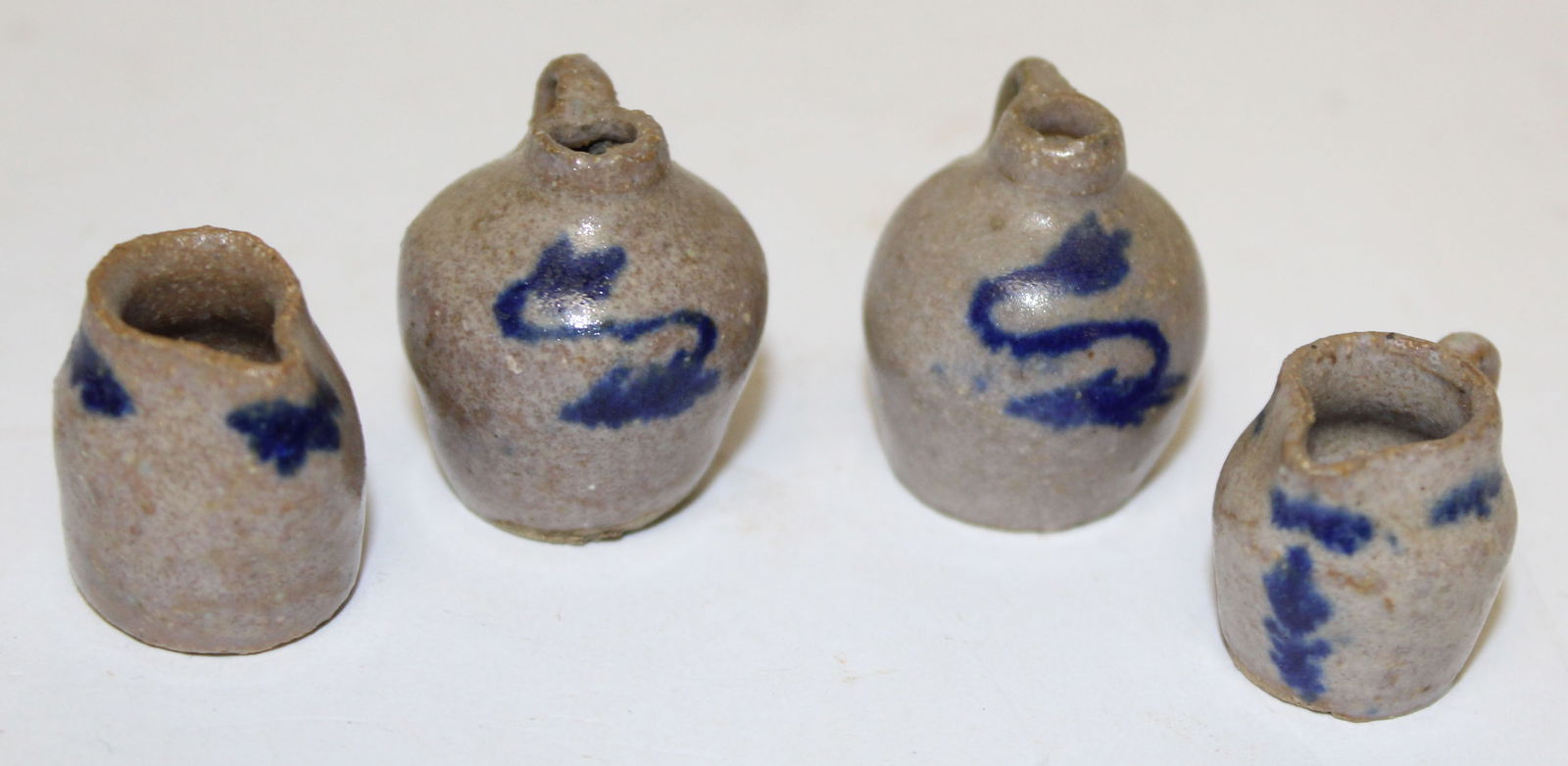 Lot of 4 miniature stoneware cobalt dec pitchers & jugs - 1/2"-1" tall some sgnd NS (1 of 4)