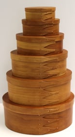Stack of contemporary Shaker graduated oval finger lapped pantry boxes marked Canterbury Woodworks