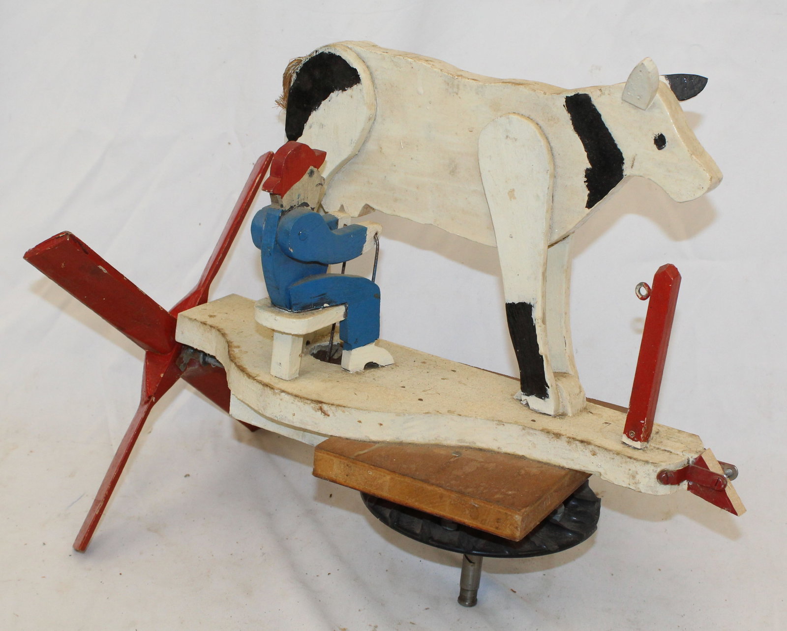Folk Art wooden painted whirligig of farmer milking a cow - 15"x18": Folk Art wooden painted whirligig of farmer milking a cow - 15"x18"