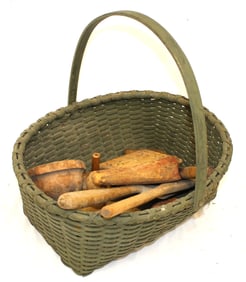 Lot of antique wooden utensils incl butter stamps, funnel, spoons & paddles in green painted basket