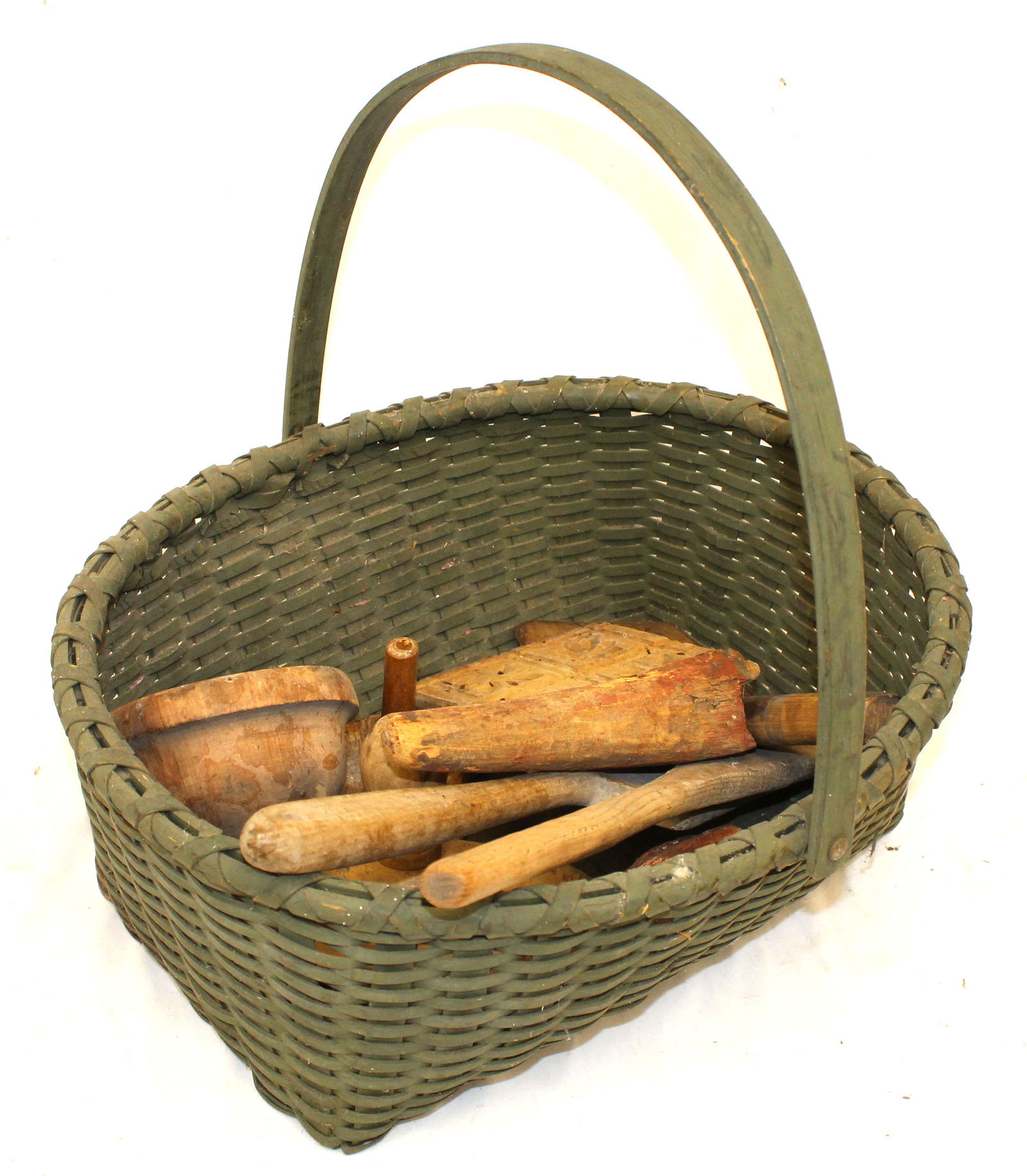 Lot of antique wooden utensils incl butter stamps, funnel, spoons & paddles in green painted basket (1 of 9)