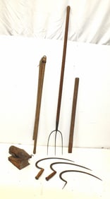 Lot of antique farm implements incl sickles, pitchfork, flail, bee smoker, etc