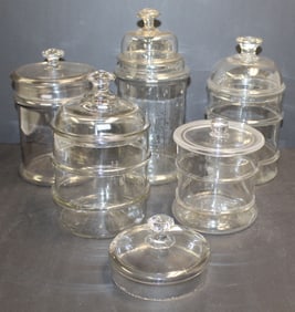 Lot of 5 glass apothecary jars in various shapes & sizes plus an extra lid/cover - 5" diam extra lid