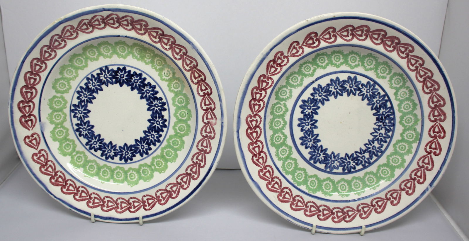 Pair of Stick Spatter plates in red, green & blue - w hearts border & floral centers - 10 1/4" diam (1 of 9)