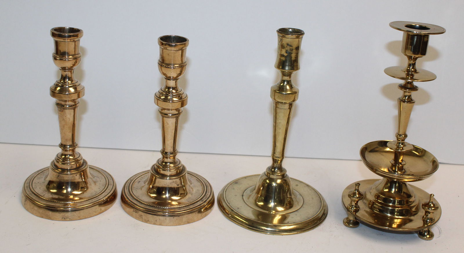 Lot of 4 antique candlesticks incl 2 bell metal, a brass baluster & a single brass - 7"-8 1/4" tall (1 of 7)