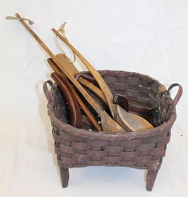 Lot of antique treen spoons & paddles in a footed red painted basket - basket is 10" tall x 13