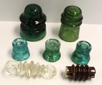 Lot of 7 glass insulators in green, aqua & amber - 2 3/4" - 3 3/4"