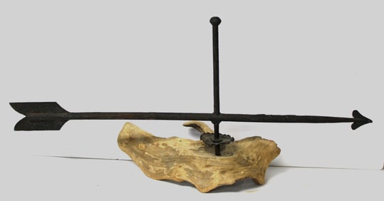 Iron arrow weathervane mounted on stump