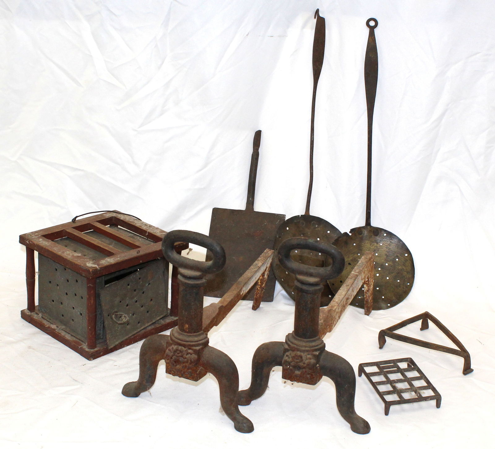 Lot of antique fireplace related incl andirons, footwarmer, trivets, & 2 pierced spoons: Lot of antique fireplace related incl andirons, footwarmer, trivets, & 2 pierced spoons