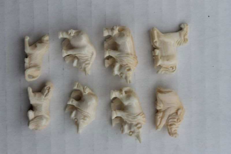 8 Chinese carved ivory animals - 4 buffalo; 2 dogs; a b: 8 Chinese carved ivory animals - 4 buffalo; 2 dogs; a boar & a horse - 1 1/4"