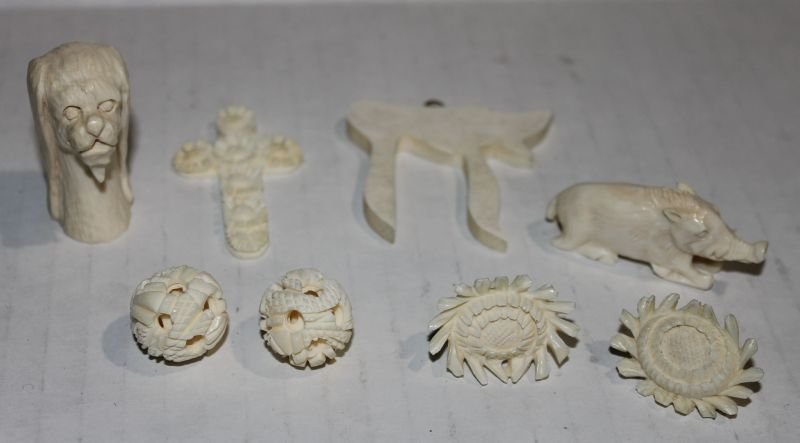 8 pc Chinese carved ivory grouping - 1 3/4" dog; 2" cru: 8 pc Chinese carved ivory grouping - 1 3/4" dog; 2" crucifix; 2" boar; pr of 3/4" mystery balls; 2" character & a pr of lotus earrings