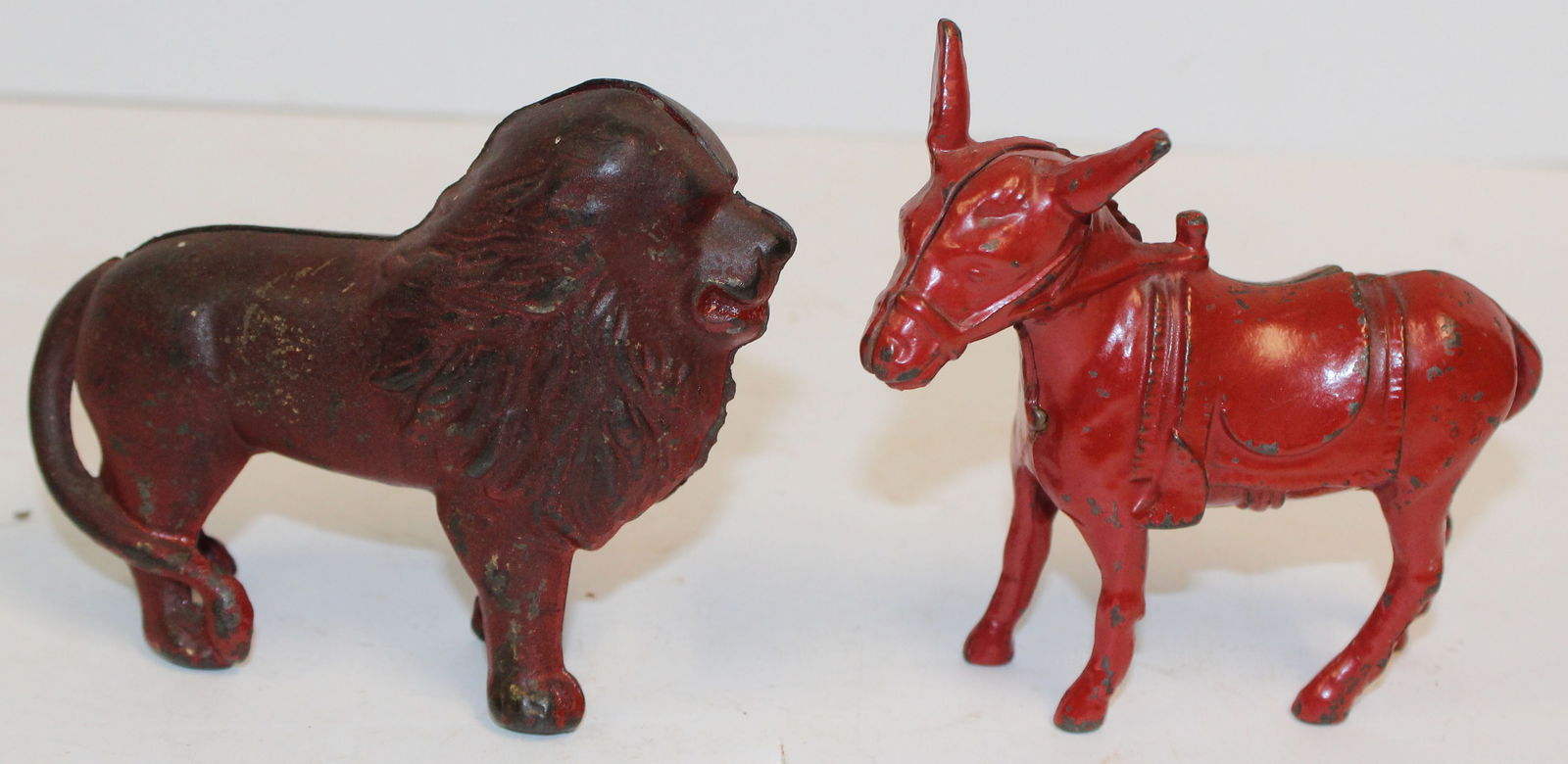 Lot of 2 antique cast iron still banks in red paint incl Lion & Donkey - 4" tall x 5" long & 4" tall (1 of 6)