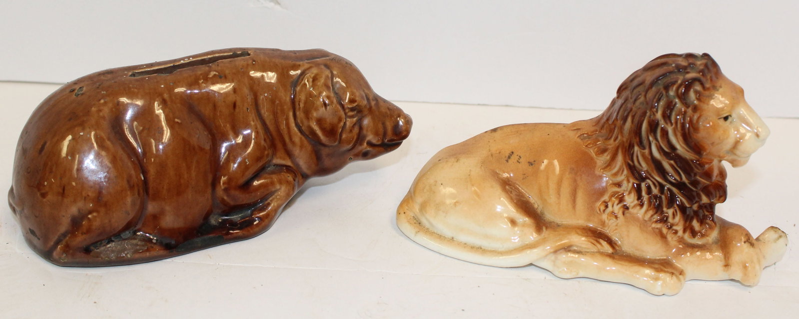 Lot of 2 vintage porcelain still banks - Lion & Pig - 3"x7" & 3 1/2" x 5": Lot of 2 vintage porcelain still banks - Lion & Pig - 3"x7" & 3 1/2" x 5"