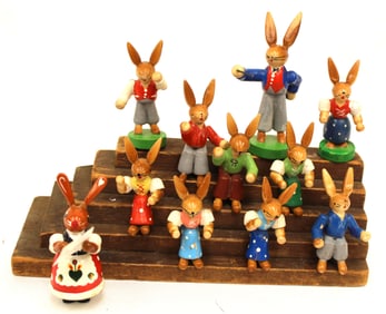 Rabbit Music class on wooden stand w many wooden painted rabbit figures - steps are 3" tall x 7"