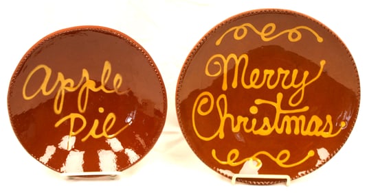 Lot of 2 Contemporary redware plates w slip decoration - "Merry Christmas" & "Apple Pie" - 10 1/2" &