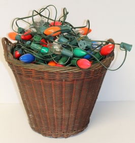 Basket filled with working strings of multi colored Christmas lights plus a basket of extra bulbs