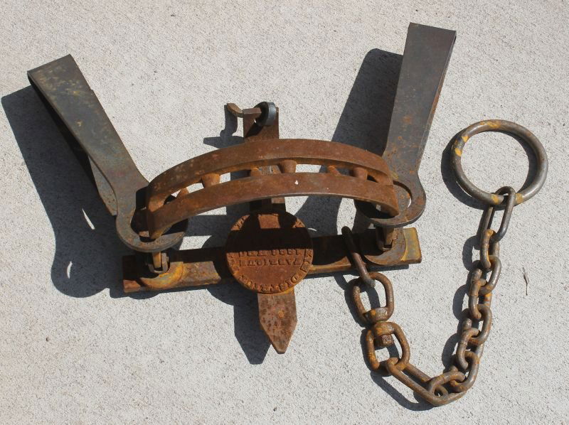 large antique iron bear trap marked Mackenzie District