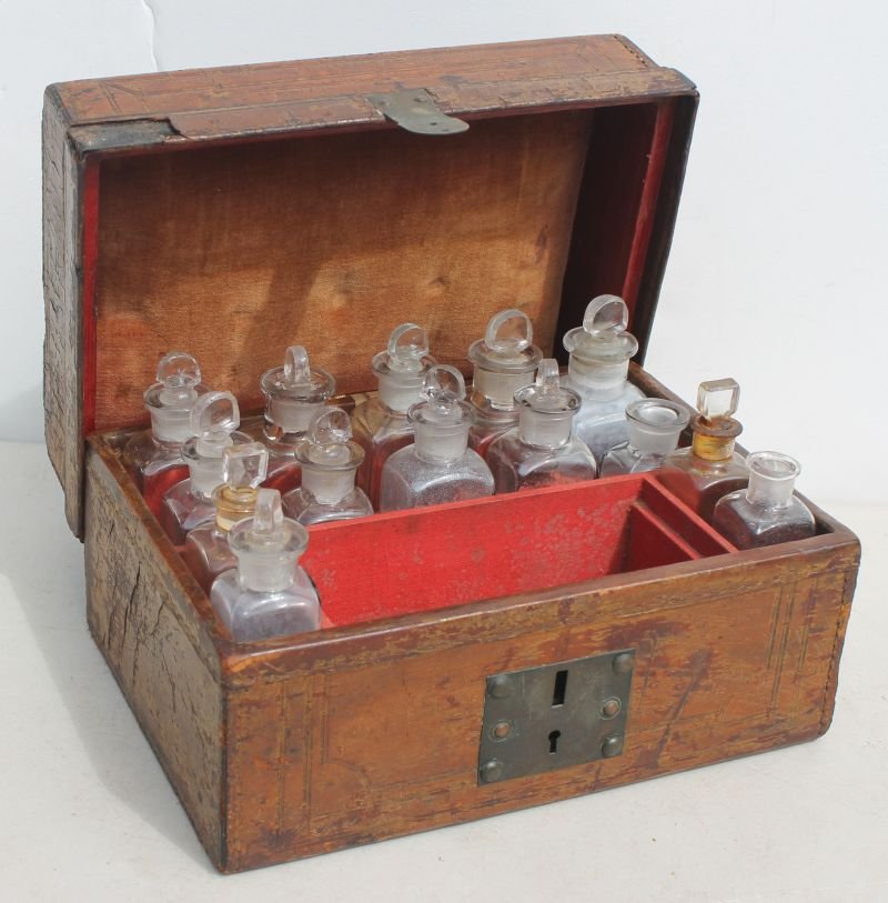 19thC tooled leather apothecary or medical box w compar: 19thC tooled leather apothecary or medical box w compartmented interior containing 14 early bottles - 9" wide x 5 1/2" tall x 6 1/2" deep