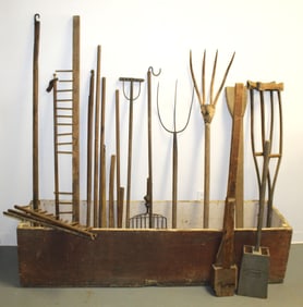 Antique grain bin (no lid) filled w antique wooden handled farm implements - grain bin is 16 1/2"