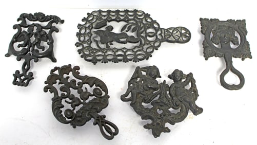 Lot of 5 antique cast iron figural motif trivets -