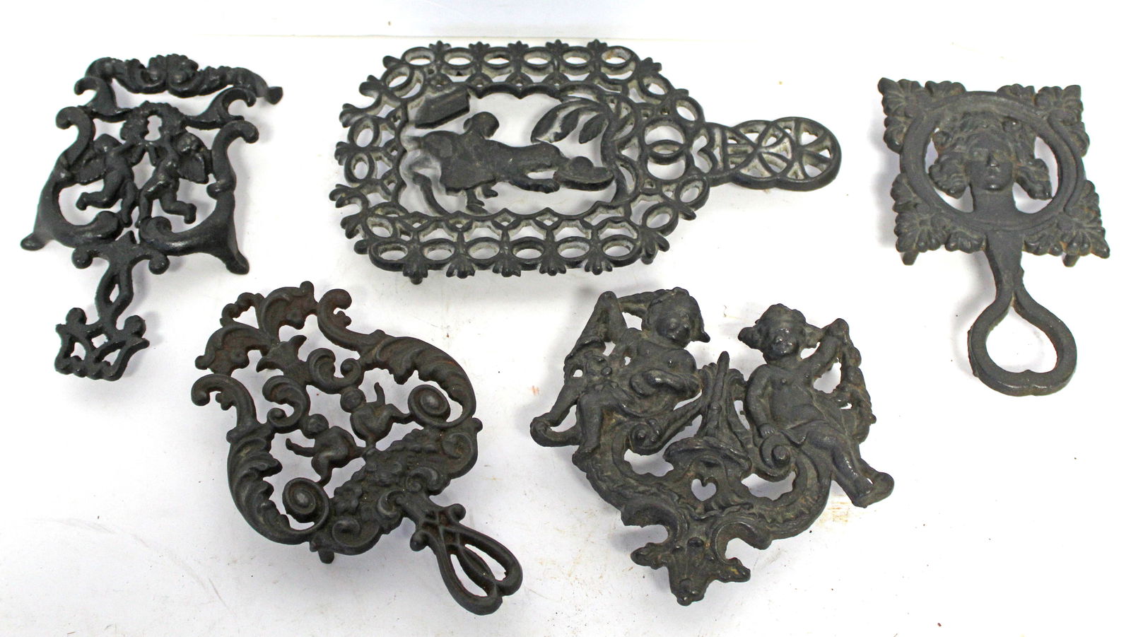 Lot of 5 antique cast iron figural motif trivets - (1 of 6)