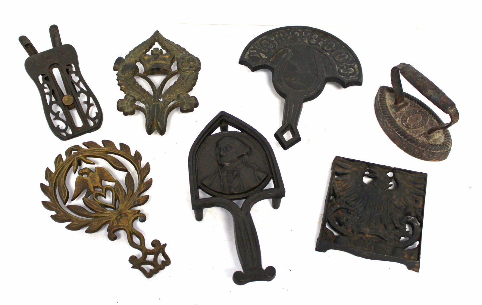 Lot of 6 antique cast iron trivets plus a sad iron - 5 1/2"-9" (1 of 8)